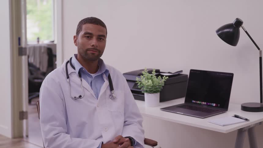 A doctor sitting in an office at a desk