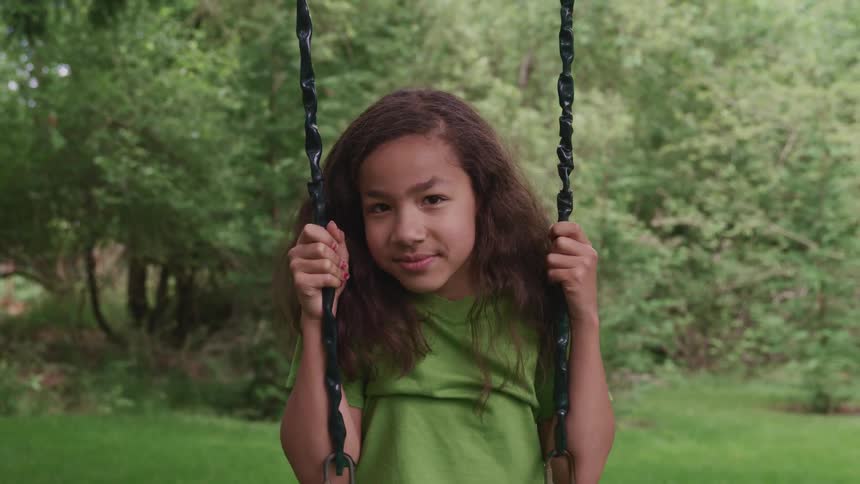 A portrait of a girl on a swing