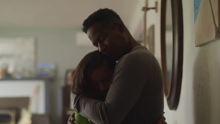 Father and daughter huging in the living room at home