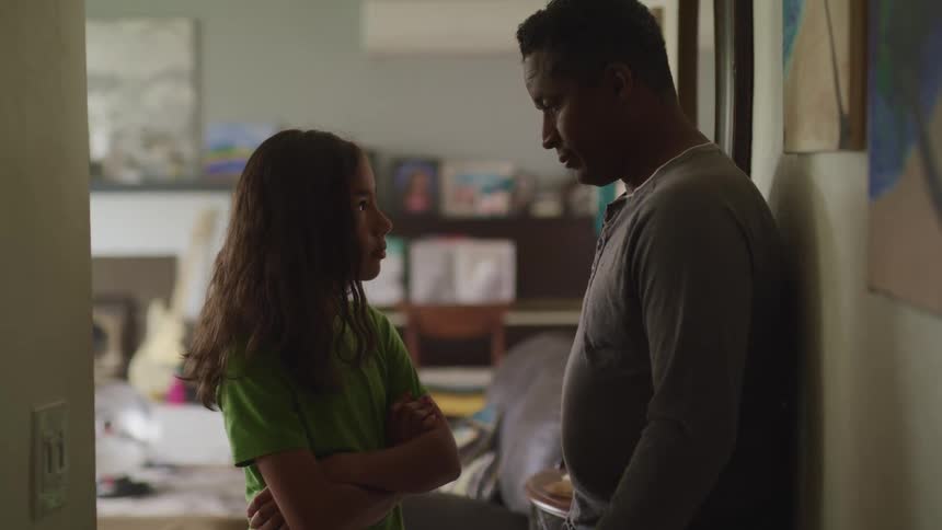 A father and daughter stand across from each other hanging their head in disappointment
