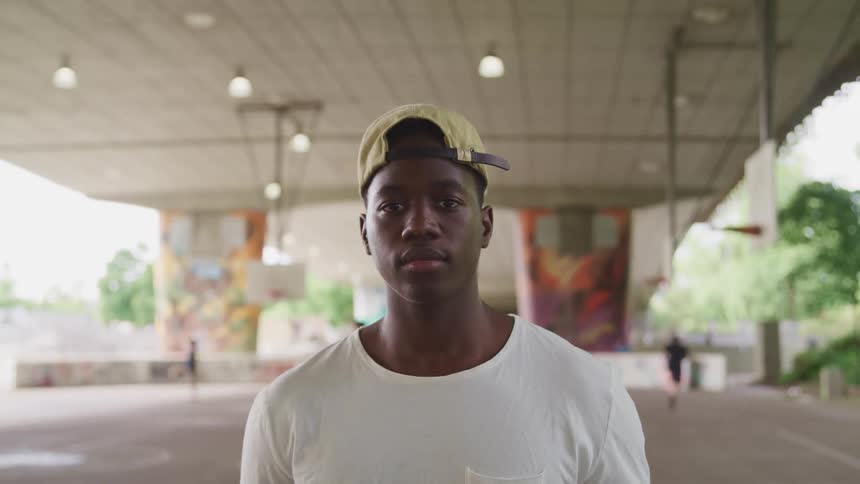 A portrait of a man on a basketball court