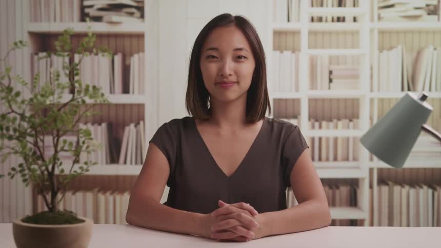 A portrait of a woman sitting at a desk