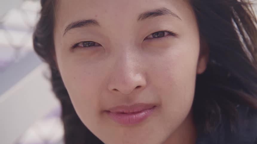 Woman with straight hair stares at the camera