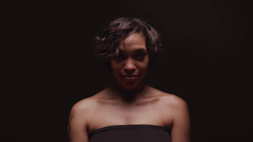 A woman standing in a room with a wall in the background