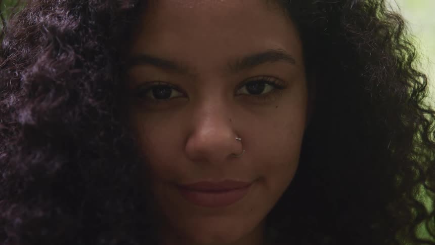 A woman with a nose ring smiles