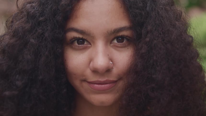 A woman with a nose piercing posing for a portrait