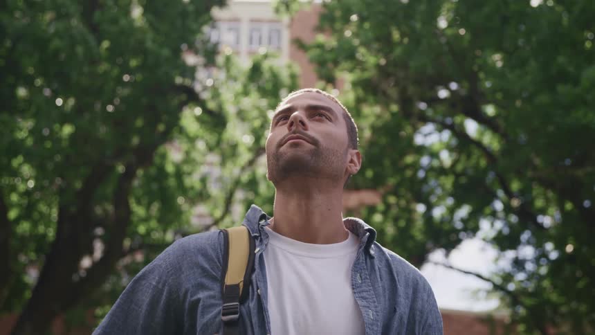 A portrait of a man that is standing outdoors