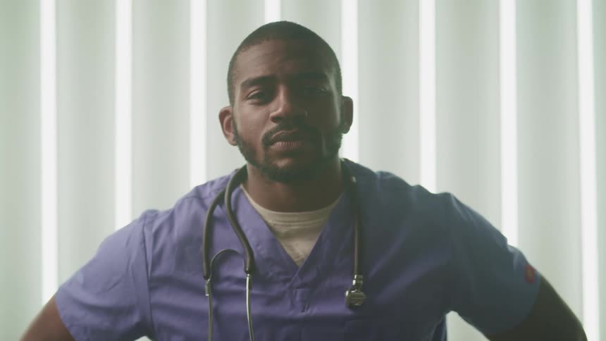 A doctor is standing in the patient room