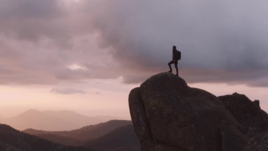 Man standing on a rock on a cliff