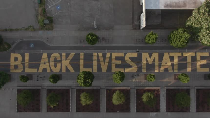 An aerial view of black lives matter painted on concrete