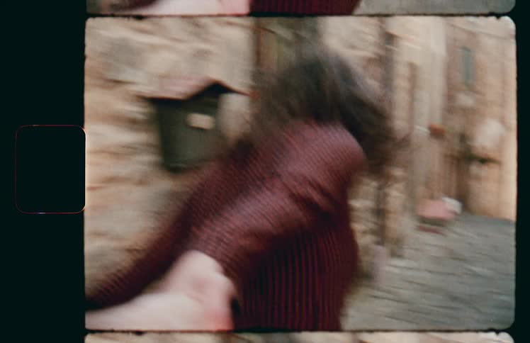 A woman walking in an alleyway while holding hands with someone