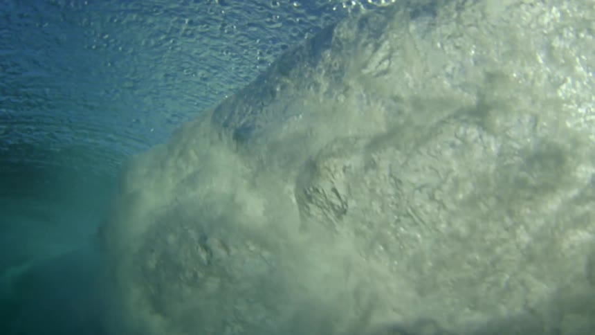 Huge wave rolls overhead and an underwater view