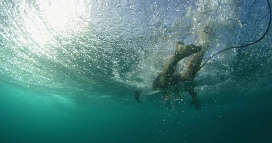 A surfer is rising towards the top of the water