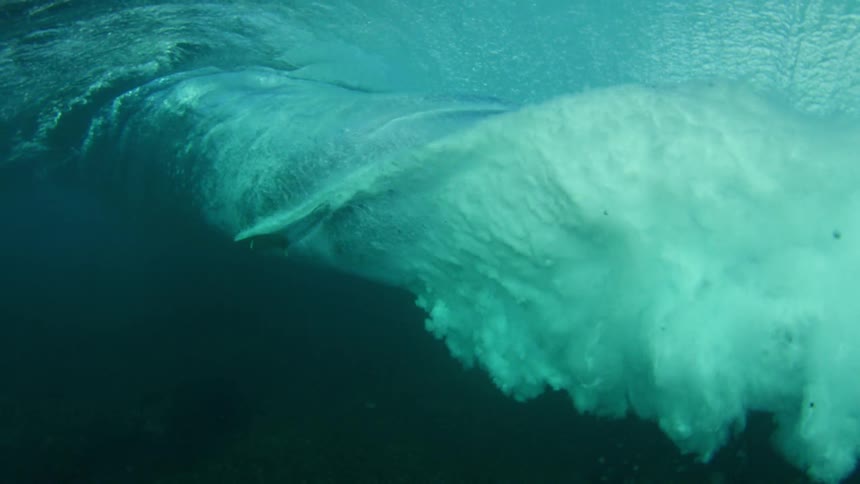 surfer pass by underwater
