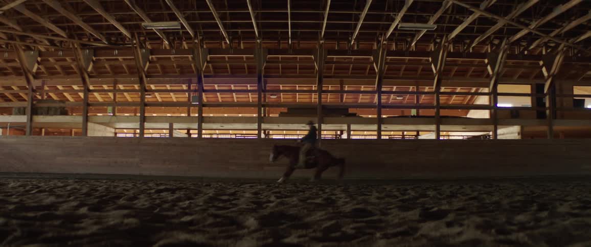 A person that is riding a horse in a building