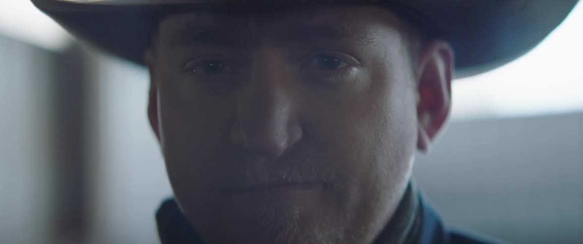 Man wearing a cowboy hat looking at the camera