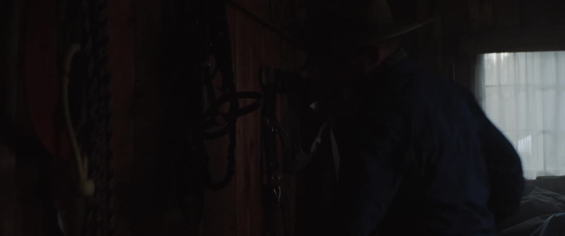A man walks through his dark house