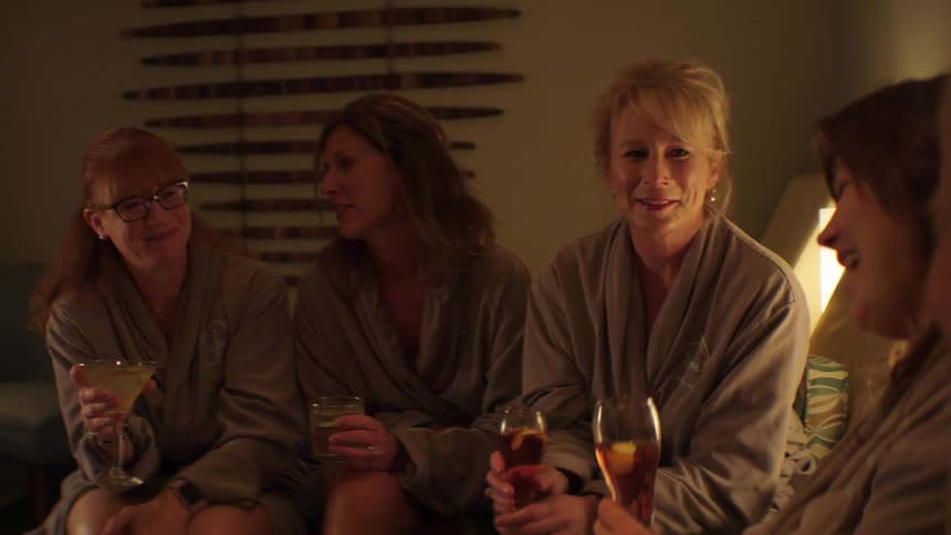 A group of women talking and drinking wine