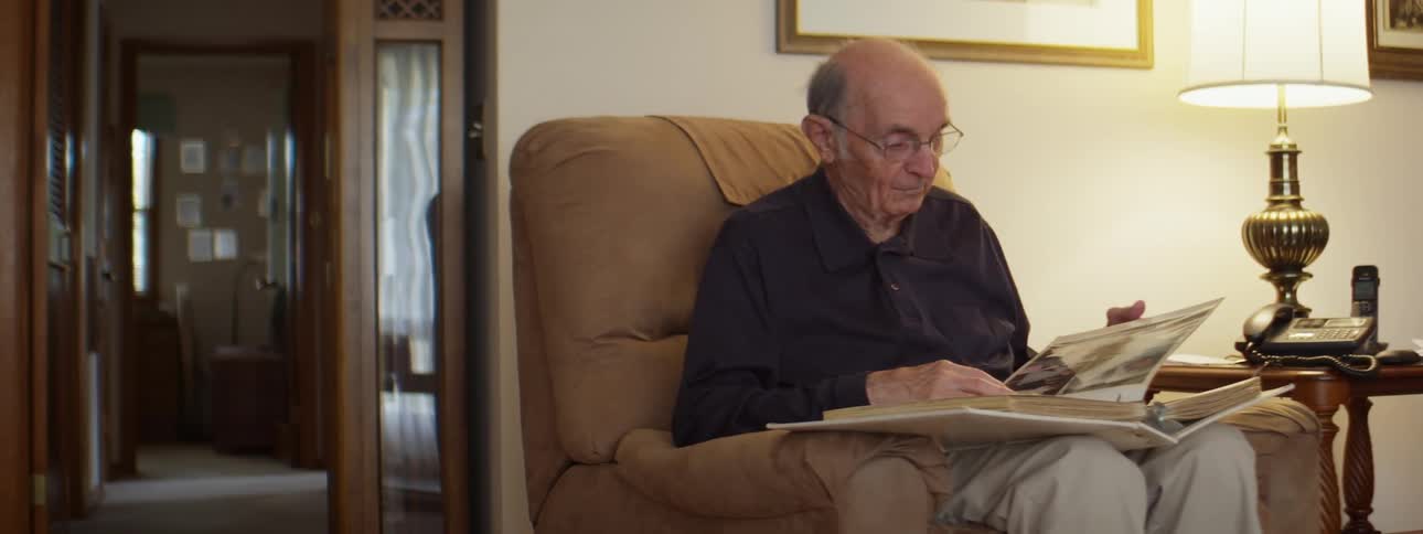 A man is flipping through a photo album