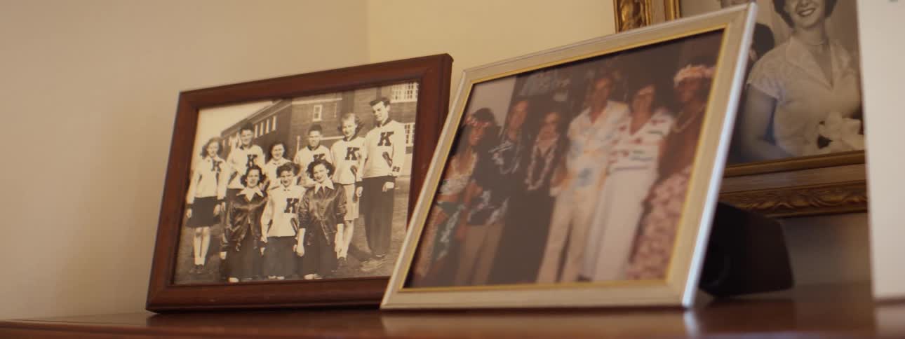 Vintage pictures in frames displayed on a shelf