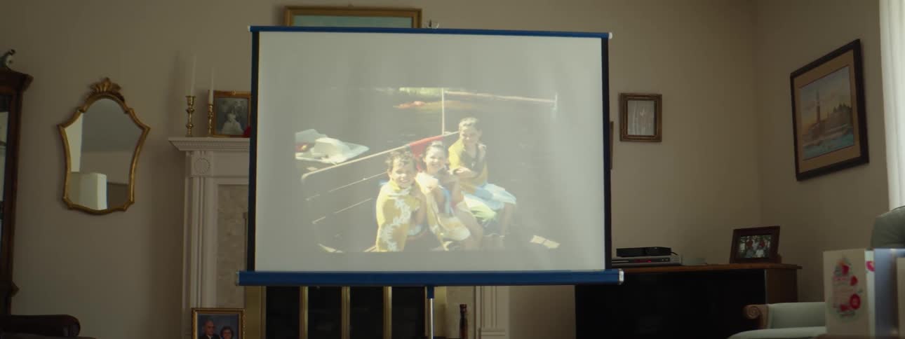 Slides projected on a screen in the living room at home