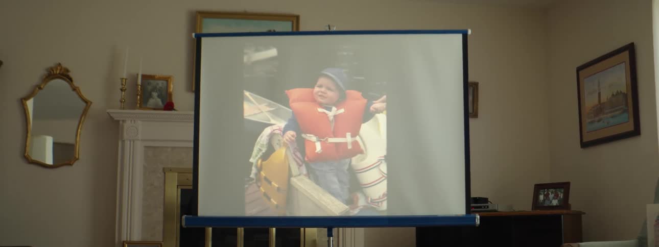 Pictures are shown on projection screen setup in living room