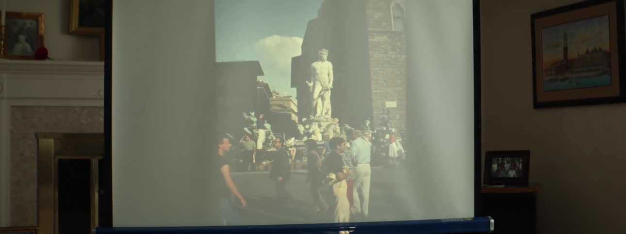 Photographs being projected onto a screen inside a room