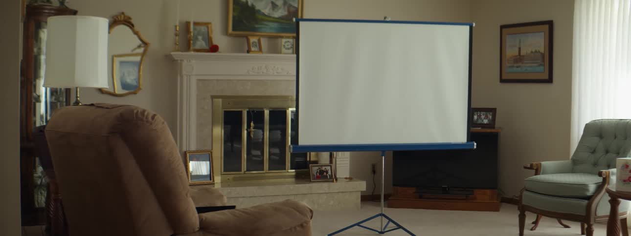 Slides projected on a screen in the living room of a house