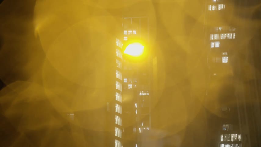 Tall buildings in a metropolis at night