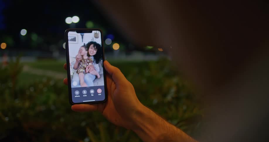 A person talking to people on a phone outdoors
