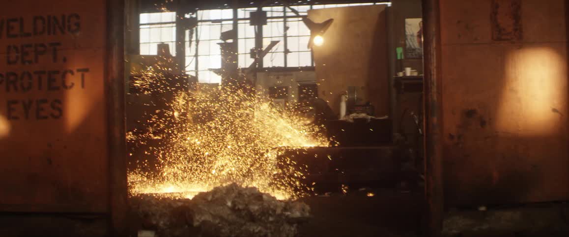 Sparks fly as a welder works in a factory