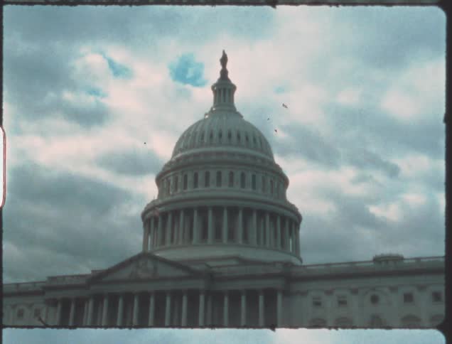 The dome of the capitol building on a cloudy day