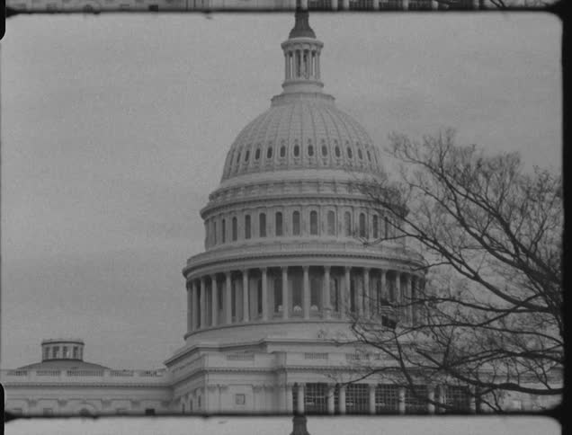 The capital building has a statue at the top