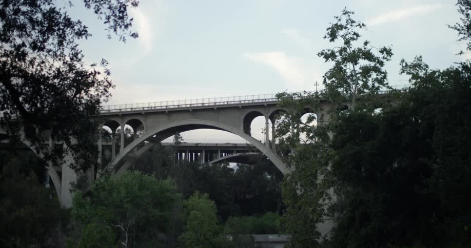 Cars drive across a bridge in the distance
