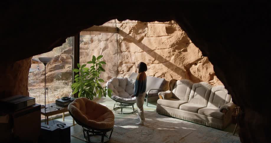 A woman looks around a living room