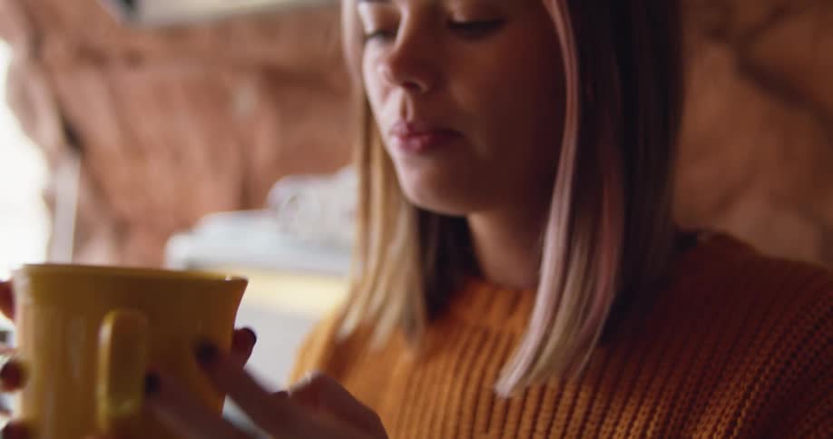 A woman drinking from a mug