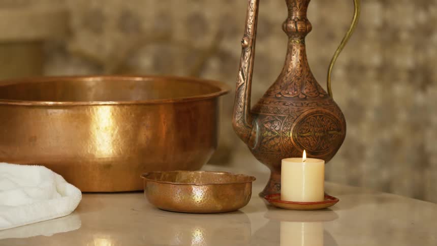 A view of a pitcher bowl and candle on a table