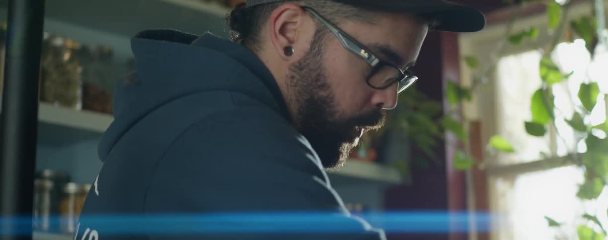 Bearded man cleaning a counter top in the kitchen