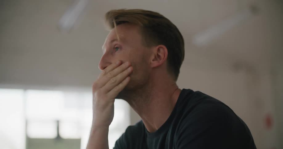 A man sitting in a room thinking