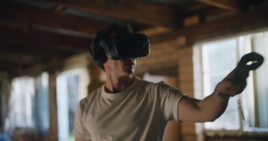 A man that is using a vr headset in a house