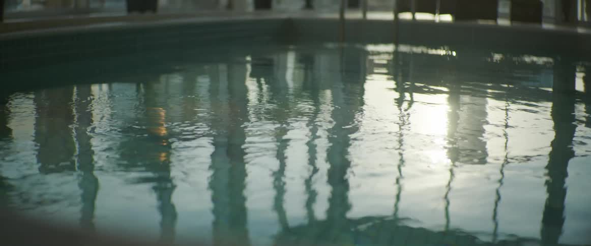 Sunlight reflecting on the surface of the water inside a pool at morning