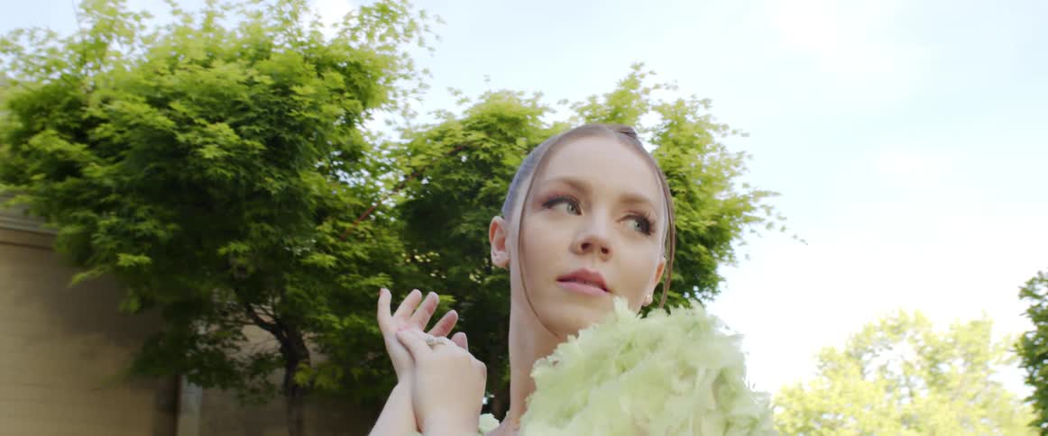 A portrait of a woman standing outdoors