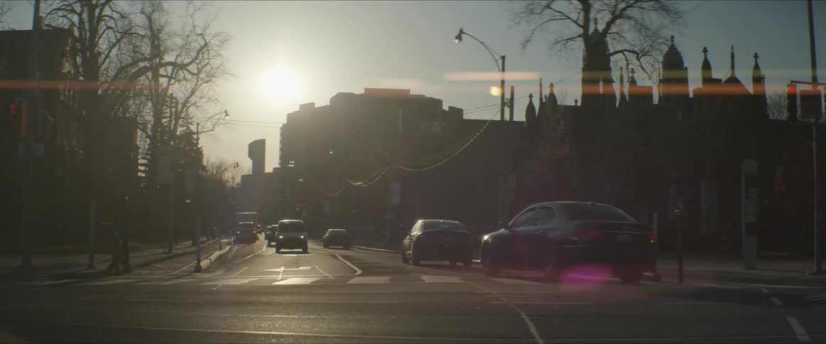 Traffic travels through an intersection in a city during the day