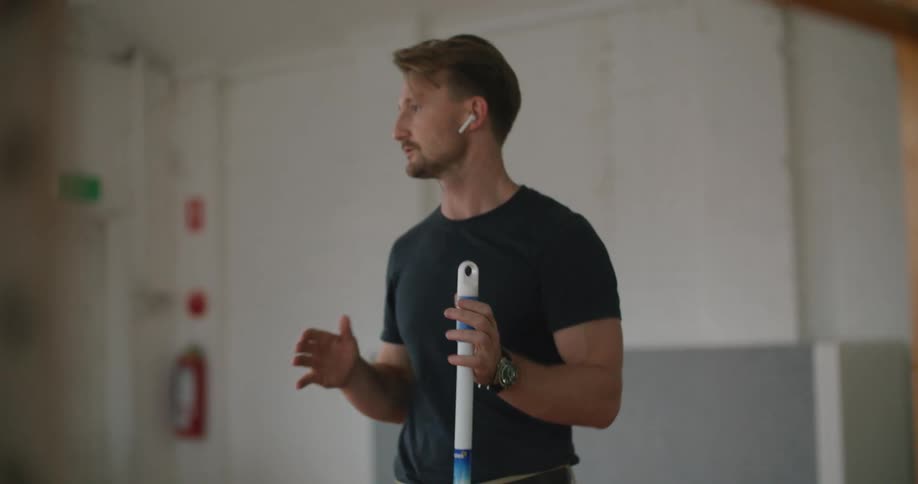 A man working with a mop in an office
