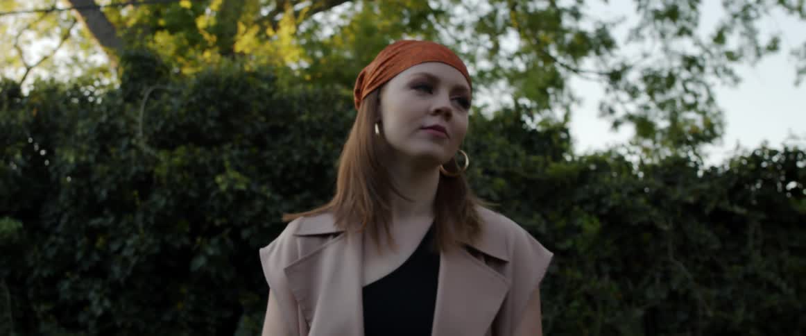 Woman wearing a red headband modeling for a photo shoot in the morning