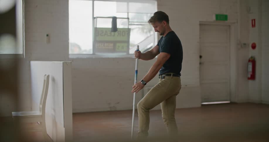 An employee mopping a floor