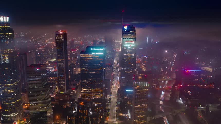 Aerial time lapse of a large city with high rise buildings at night