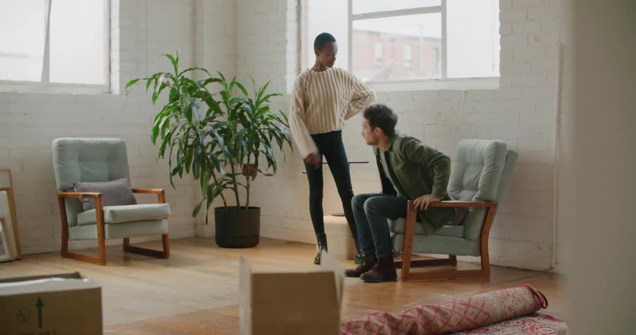 A man and woman sitting in a chair and talking