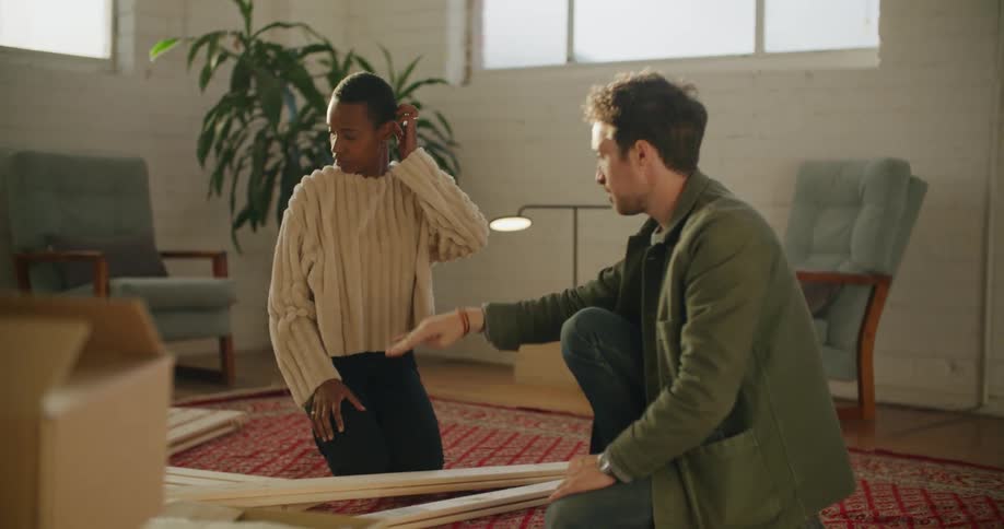 A man and woman assembling furniture