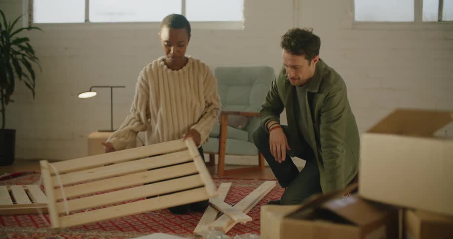 A man and woman assembling furniture